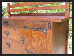 Detail of exposed tenon at the top of the front leg and the hammered iron strap door hinges.
